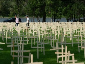 Row upon row of wooden crosses meant to represent the lives lost in Saskatchewan to drug overdose line the grass in the park across from the Saskatchewan Legislative Building in Regina, Saskatchewan on August 31, 2021. The crosses were erected for an event marking National Overdose Awareness Day.