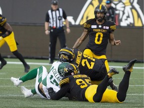 Saskatchewan Roughriders quarterback Zach Collaros is hit late by Hamilton Tiger-Cats' Simoni Lawrence, 21, in the CFL's 2019 regular-season opener. Collaros never played another down for the Roughriders, but finished the season on a high note when he quarterbacked the Winnipeg Blue Bombers to a Grey Cup upset victory over Lawrence and the Tiger-Cats.