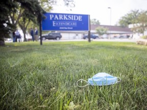 A discarded facemark sits on the ground as NDP leader Ryan Meili speaks out front of Extendicare Parkside on Thursday, August 5, 2021 in Regina. Meili was reacting to a report released by the Saskatchewan Ombudsman on the COVID-19 outbreak at Extendicare Parkside.