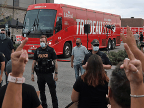 Protestors react as the media bus following Liberal Leader Justin Trudeau leaves after the cancellation of a campaign event in Bolton, Ontario, August 27, 2021.