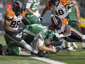 Saskatchewan Roughriders quarterback Cody Fajardo, 7, is about to be hit by the B.C. Lions' Jordan Williams during an Aug. 13 CFL game at Mosaic Stadium. Williams, who was not penalized on the play, was fined an undisclosed amount by the league on Wednesday for a hit to the head.