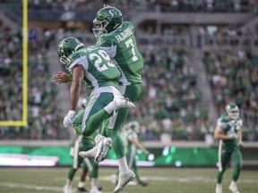 Saskatchewan Roughriders quarterback Cody Fajardo, 7, and running back William Powell, 29, celebrate the team's first touchdown on Friday against the B.C. Lions at Mosaic Stadium.