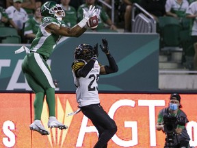 Roughriders wide receiver Shaq Evans, left, shown Saturday against the Hamilton Tiger-Cats, is to miss six to eight weeks with a broken left foot.