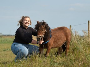 Dineke Wesdyk, who was born 20 years ago on Saturday, kneels with her miniature pony Oscar at her home south of White City. Brandon Harder/Regina Leader-Post.