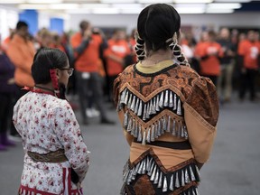 Grade 9 students Shantel Pashe, left. of LeBoldus, and Kiana Francis, of Miller, perform a jingle dance during Orange Shirt Day at the main branch go the Regina Public Library in Regina on Sept. 30, 2019.  Orange Shirt Day was developed to open the door to global conversation on all aspects of residential schools.