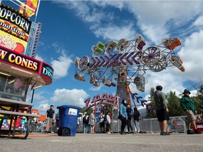 People browse the midway during the Queen City Ex at Evraz Place in Regina, Saskatchewan on August 25, 2021.