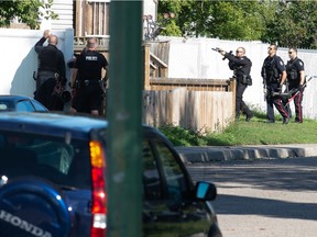 Police stand ready at a home on the 800 block of Cameron Street where they were asking residents to exit the home during a police operation in Regina, Saskatchewan on Sept. 2, 2021.

BRANDON HARDER/ Regina Leader-Post