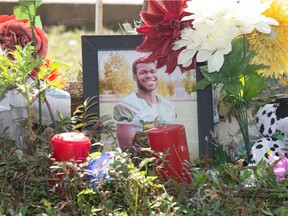 A photograph of Samwel Uko, a man who was found dead in Wascana Lake, is seen at a memorial for him set up on the lake's edge in Regina on Sept. 3, 2021.