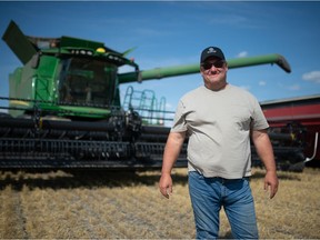 Agricultural Producers Association of Saskatchewan president Todd Lewis stands in front of his combine during harvest near Gray, Saskatchewan on Sept. 3, 2021.