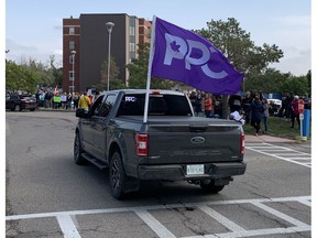 A truck with a People's Party of Canada flag drives past more than 200 people gathered near the east entrance to Saskatoon's City Hospital on Wednesday, Sept. 1, 2021 to protest mandatory proof of COVID-19 vaccination for front-line health-care workers. (Phil Tank/Saskatoon StarPhoenix)