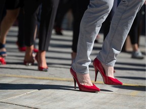 Participants walk in the YWCA Regina Walk A Mile in Her Shoes event in which began in City Square Plaza in Regina, Saskatchewan on Sept. 16, 2021. The event sees participants walk around Victoria Park, many wearing red high-heeled shoes, as a fundraiser and to raise awareness about gender-based violence.