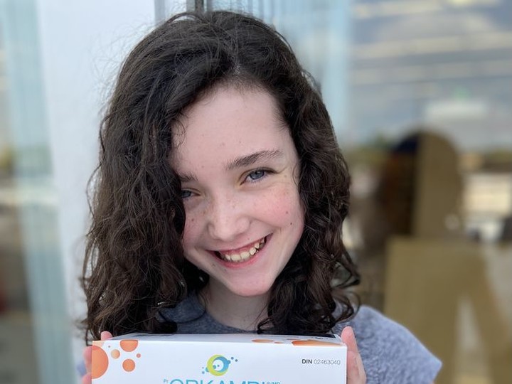  Emmanuella McDougall, 11, stands with a box of Orkambi, a medication for cystic fibrosis (CF), which she began taking in July. Ella was diagnosed with CF at just 23 days old.