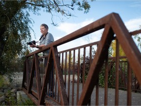 Cathy Wall stands with her camera on a bridge in the Wascana Waterfowl Park Display Ponds area in Regina on Sept. 28, 2021.