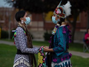 Kiana Francis, left, and Meadow Musqua dance as part of a performance to show support for those in hospital, including those suffering from COVID-19, in front of the Regina General Hospital on Sept. 28, 2021.