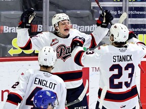 The Regina Pats' Easton Armstrong, facing camera, celebrates his first WHL goal, scored March 29 against the Swift Current Broncos at the Brandt Centre. Pats teammates Drew Englot and Sloan Stanick join in the celebration. Keith Hershmiller Photography.