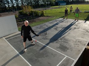 Ian Cook serves during a game of racquetball at a new outdoor court built on a rural property outside of Regina.