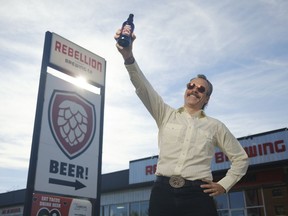 Rebellion Brewing president and CEO Mark Heise poses with a bottle of Cherry Lambic beer. Cherry Lambic, which took three years to brew, won Beer of the Year at the 2021 Canadian Brewing Awards.