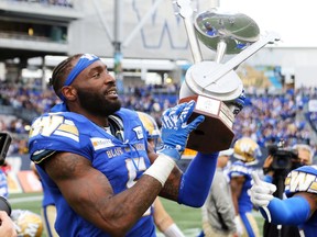 Winnipeg Blue Bombers defensive end Willie Jefferson, shown here with the Banjo Bowl trophy, poses a huge challenge for the Saskatchewan Roughriders' offensive line.