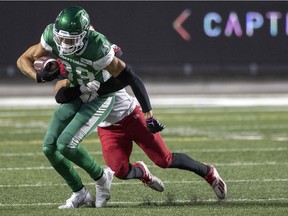 Saskatchewan Roughriders Kian Schaffer-Baker is tackled by a Calgary Stampeders defender at Mosaic Stadium on Saturday, October 9, 2021 in Regina.