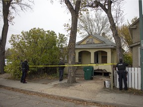 Members of the Regina Police Service investigate a home on the 1700 block of Ottawa Street on Oct. 13, 2021. Police say the body of an adult female was found at the residence in what is now declared a homicide.