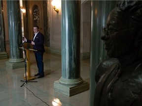 Premier Scott Moe speaks to reporters in the rotunda of the Saskatchewan Legislative Building.