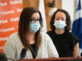 Genna Rodriguez, left, speaks about the challenges she has faced to obtain vaccination documentation during a news conference held at the Saskatchewan Legislative Building in Regina, Saskatchewan on Oct. 20, 2021. Behind Rodriguez is NDP MLA Nicole Sarauer.