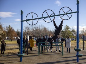 A Provincial Capital Commission employee demonstrates a new piece of fitness equipment in Wascana Centre on Friday, October 29, 2021 in Regina. The PCC announced the addition of two permanent, outdoor fitness stations to the park. The first station is located beside the Wascana Skate Plaza with Candy Cane Park located across the street, and the second is on the north side of the Wascana Rehabilitation Centre.