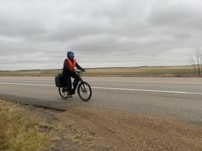 Regina-based writer and climate organizer Laura Stewart rides her bike near Edgeley, Sask. on her way to Melville. The 150-kilometre bike ride was part of her trip to Winnipeg to push for just transition legislation from the federal government.