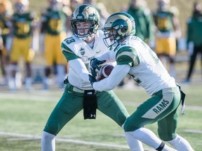 University of Regina Rams quarterback Bryden O'Flaherty, left, hands off to Kyle Borsa on Saturday versus the host University of Alberta Golden Bears in Canada West football action. Borsa rushed for 113 yards for the Rams, who blew a 22-5 fourth-quarter lead and lost 23-22 in Edmonton.