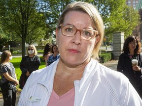 Registered nurse Anita Davis said she has received a notice from London Health Sciences Centre that she will be fired Friday for refusing to get vaccinated for COVID-19 as required by the hospital. Davis, who spoke Wednesday at a rally at Victoria Park in London, said she and other unvaccinated workers at LHSC aren't putting people at risk because the hospital has an excellent infection control program. (Mike Hensen/The London Free Press)