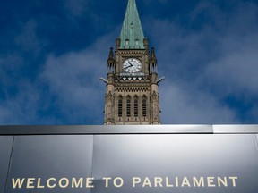 The Peace tower is seen above a welcome sign on Parliament Hill in Ottawa.