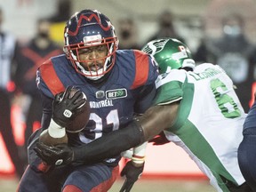 Montreal Alouettes running back William Stanback, left, is tackled by Saskatchewan Roughriders' A.C. Leonard during Saturday's game at Percival Molson Stadium.