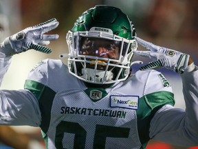 Saskatchewan Roughriders receiver Kyran Moore celebrates his touchdown during second half of Saturday's 20-17 win over the Calgary Stampeders. Jeff McIntosh/The Canadian Press.