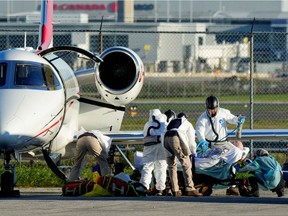 Medical personnel transfer a patient from an air ambulance which departed Regina, Saskatchewan to a waiting ambulance at Pearson International Airport in Mississauga, Ontario, Canada October 27, 2021.   REUTERS/Carlos Osorio
