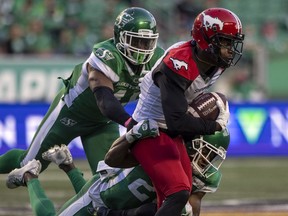 REGINA, SASK :  October 9, 2021 --  Calgary Stampeders wide receiver Hergy Mayala (1) is tackled by a pair of Saskatchewan Roughriders defenders at Mosaic Stadium on Saturday, October 9, 2021 in Regina.

TROY FLEECE / Regina Leader-Post