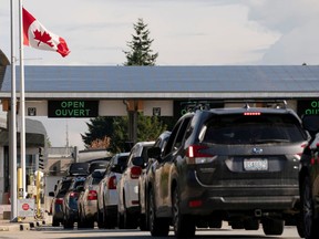 Cars line up at the Canadian border crossing in Blaine, Wash., on Aug. 9.