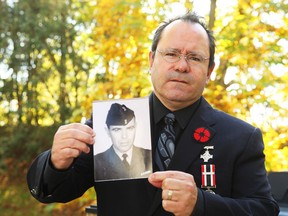 John Moses holds a photo of his father, Russ Moses who joined the military after residential school in Brantford, Ont. and wrote a searing testimony against residential schools in 1965. Jean Levac/Ottawa Citizen
