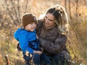 Elijah Buckley sits with his mother Keeley Buckley. Elijah has had an upcoming surgery indefinitely postponed because of the pressure COVID-19 is putting on Saskatchewan's Intensive Care units.