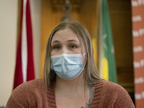 Jessica Edie, who is currently waiting for a leg procedure after having hers cancelled, speaks with reporters at the Saskatchewan Legislative Building on Nov. 10, 2021.