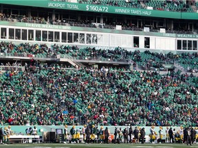 Fans sit in the stands during a CFL football game between the Edmonton Elks and the Saskatchewan Roughriders in Regina, Saskatchewan on Nov. 13, 2021.