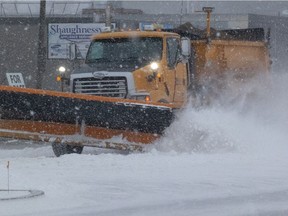 Snow clearing equipment moves along Park Street in Regina, Saskatchewan on Nov. 17, 2021.