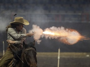 Kyla Quiring, of Turner Valley, Alberta, takes part in the Cowboy Mounted Shooting elimination finals as part of the 50th anniversary of the Canadian Western Agribition on Saturday, November 27, 2021 in Regina.