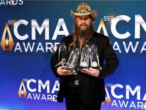 Chris Stapleton poses with his awards for Male Vocalist of the Year, Album of the Year, Single of the Year and Song of the Year.
