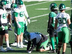 Saskatchewan Roughriders centre Dan Clark (middle) left Tuesday's practice early due to an ankle injury. The severity of Clark's injury wasn't known.