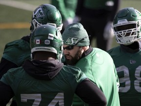 Saskatchewan Roughriders defensive line coach Ben Olson (centre) works with his players during practice at Mosaic Stadium earlier this week.