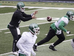 Saskatchewan Roughriders quarterback Cody Fajardo accepts a snap during Wednesday's practice at Mosaic Stadium.