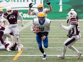 Saskatoon Hilltops quarterback Damon Dutton scores on a six-yard run against the Regina Thunder in the PFC final Sunday at Mosaic Stadium.