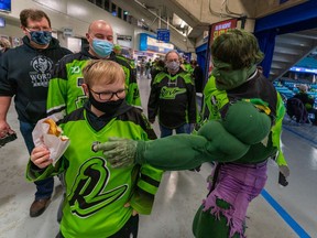 Saskatchewan Rush Superfan Kelvin "Rush Hulk" Ooms, right, points at an attendee's food before National Lacrosse League action at Sasktel Centre in Saskatoon, SK on Saturday, December 11, 2021.