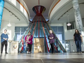 Brenda Green, from left, Colleen Strongarm, Kathleen O'Reilly and Elizabeth Cooper stand in the foyer of the First Nations University of Canada on Thursday, December 16, 2021 in Regina.