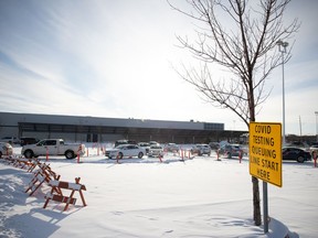 Vehicles line up at a Saskatchewan Health Authority COVID-19 testing site at the former Costco location off University Park Drive on Tuesday, Dec. 28, 2021. The SHA's website was estimating a 3-4 hour wait for testing on Tuesday afternoon.